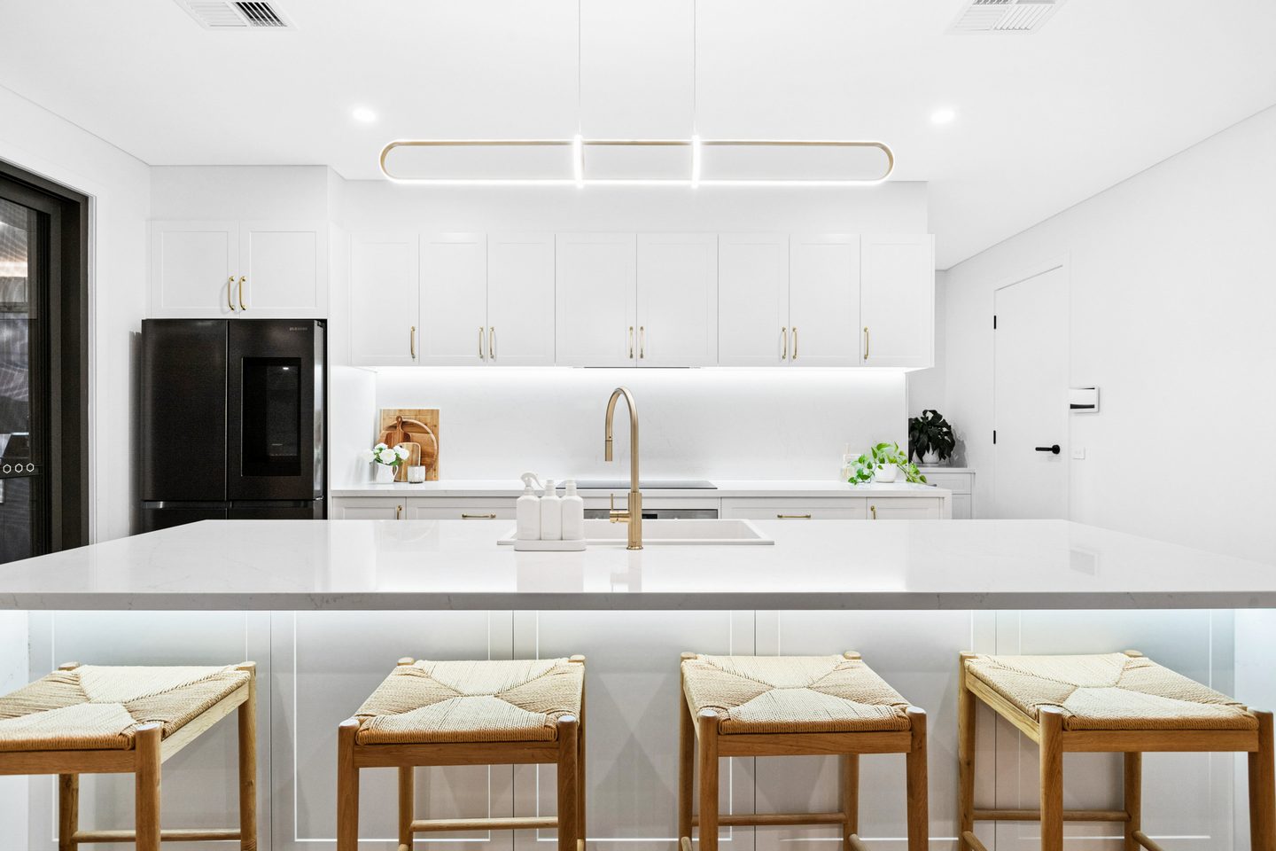 The island bench and kitchen cabinetry