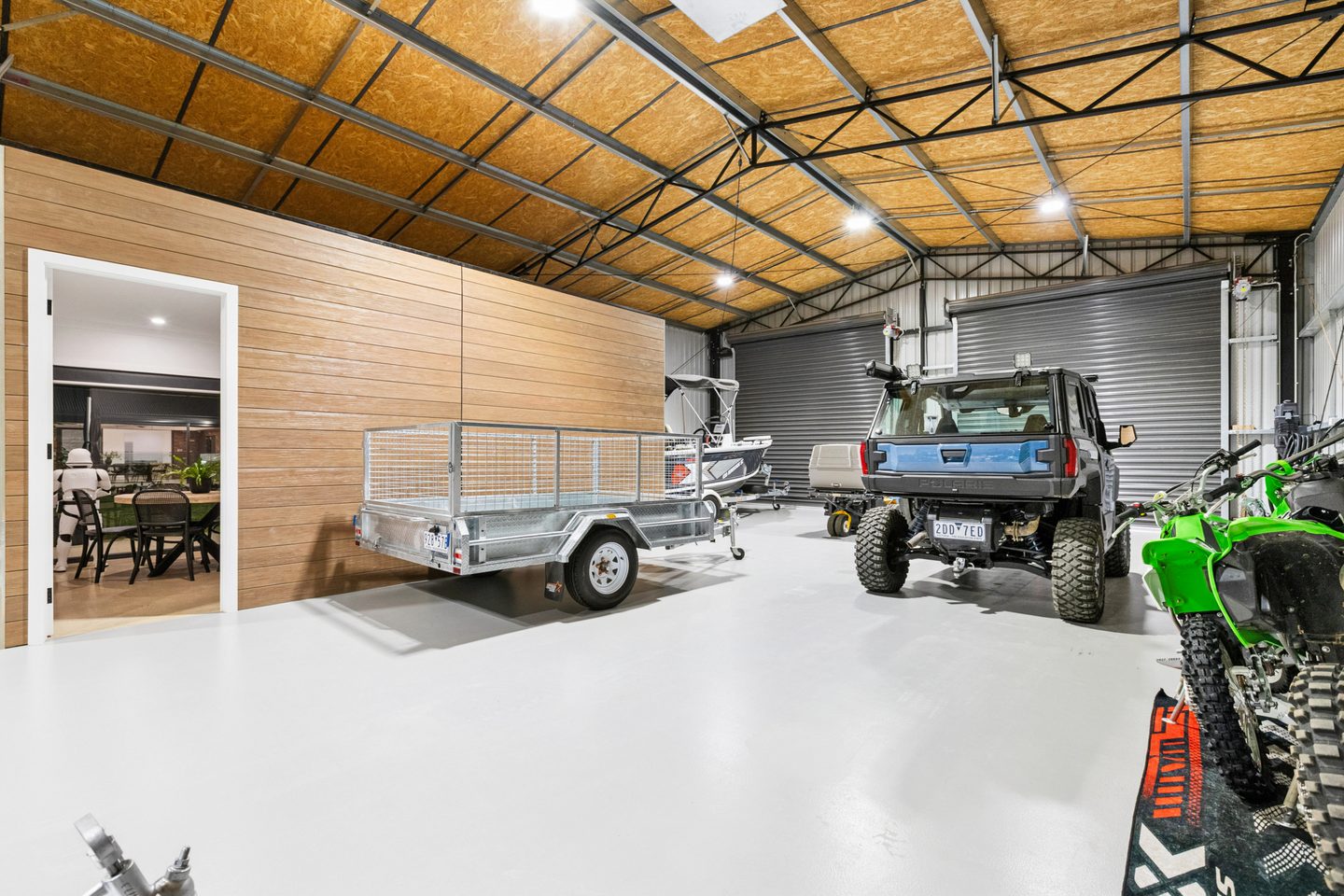 Workshop interior with roller-door access and an enclosed office