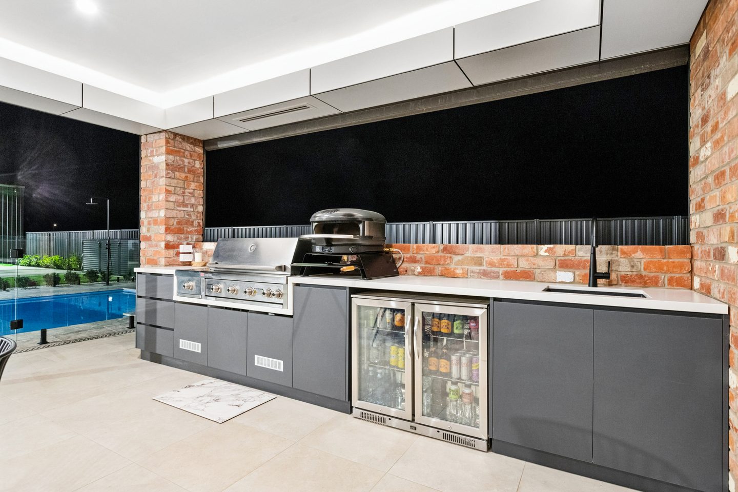 Outdoor kitchenette with built-in barbecue, pizza oven and refrigerator