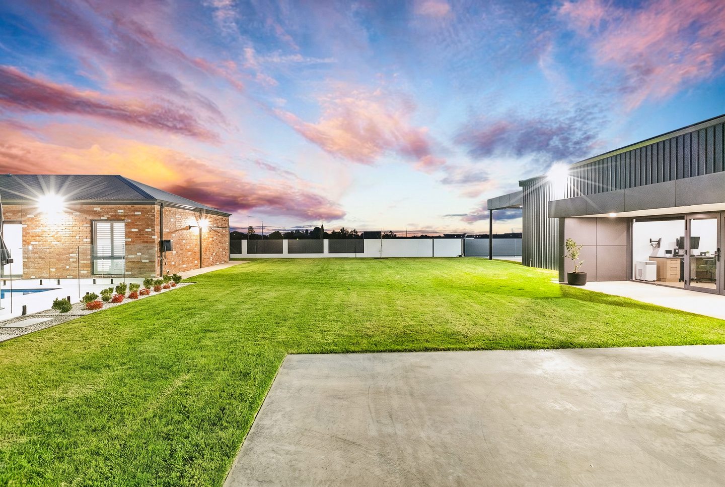 The lawn between the home and shed