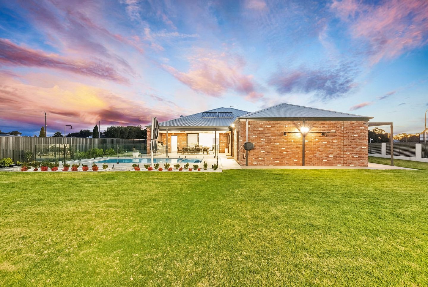 The home and pool viewed from the lawn