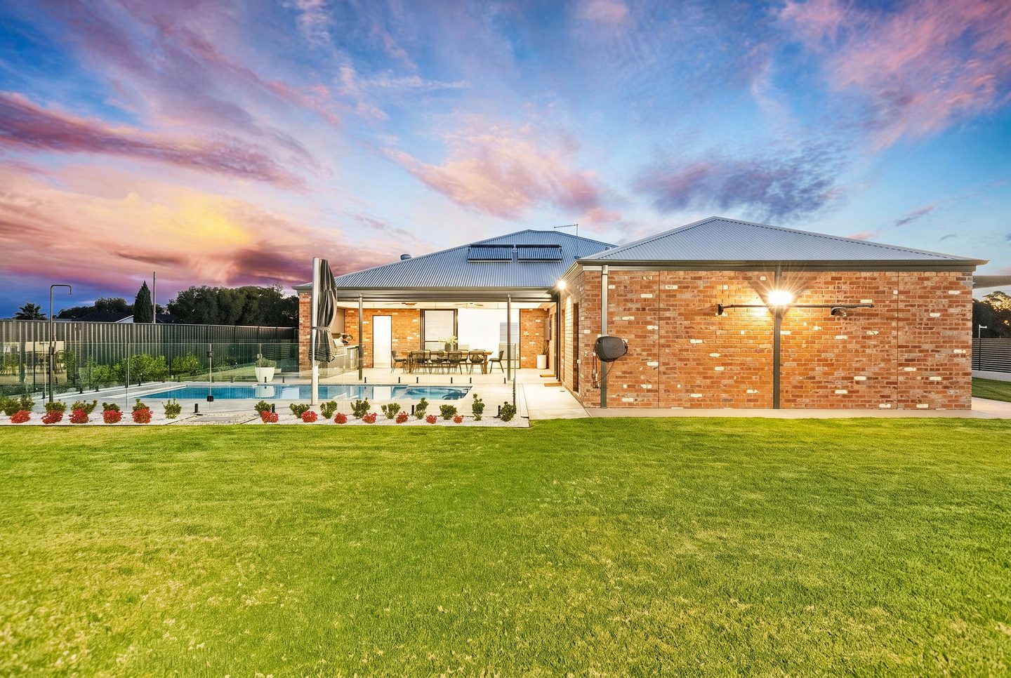 The rear garden and poolside elevation