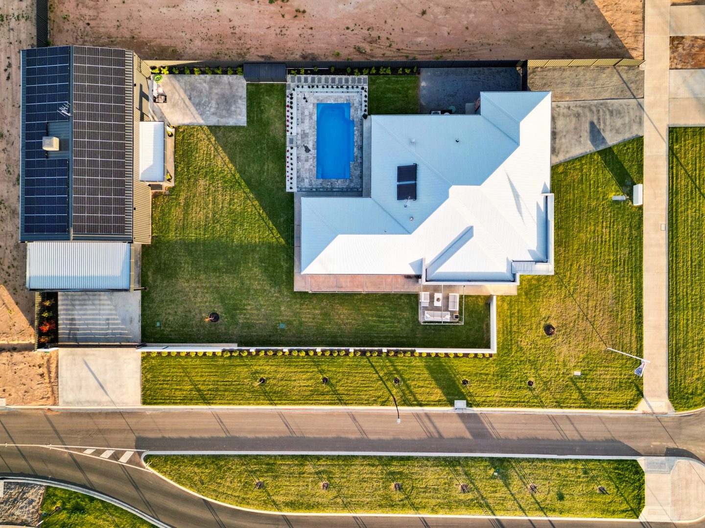 Overhead view of the home, pool, lawn and solar panels on the shed